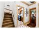 Hallway features stairs, art, and a doorway to the laundry room at 1800 Bay Meadow Ct, Raleigh, NC 27615