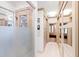 A hallway reveals bathroom and bedroom areas featuring custom doors and a mirrored closet at 1800 Bay Meadow Ct, Raleigh, NC 27615