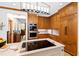 Kitchen showcases custom lighting, cooktop island, and high-end appliances with hardwood cabinets at 1800 Bay Meadow Ct, Raleigh, NC 27615