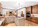 Large kitchen featuring island cooktop, double ovens, and an open layout to the living area at 1800 Bay Meadow Ct, Raleigh, NC 27615