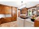 This open kitchen boasts custom wood cabinets, modern appliances, and an island with a cooktop at 1800 Bay Meadow Ct, Raleigh, NC 27615