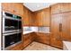 Gourmet kitchen featuring stainless steel double oven, custom cabinets, and ample counter space at 1800 Bay Meadow Ct, Raleigh, NC 27615