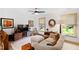 Cozy living room with television, comfortable light sofa and views from the bright, sunny windows at 1800 Bay Meadow Ct, Raleigh, NC 27615