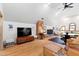 Inviting living area featuring hardwood floors, a brick chimney, a ceiling fan and a cozy atmosphere at 1800 Bay Meadow Ct, Raleigh, NC 27615