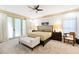 This main bedroom features neutral decor, a ceiling fan, and French doors leading to a private outdoor space at 1800 Bay Meadow Ct, Raleigh, NC 27615