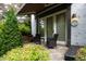 Cozy outdoor patio with comfortable seating, a striped awning, and lush plants offers a relaxing retreat at 1800 Bay Meadow Ct, Raleigh, NC 27615