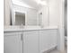 Bathroom features double sink vanity with white cabinetry, a large mirror, and modern fixtures at 912 Allen Park Dr, Raleigh, NC 27604
