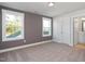 Bedroom featuring neutral carpet, two large windows, and an ensuite bathroom at 912 Allen Park Dr, Raleigh, NC 27604