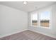 Bright bedroom features neutral walls, plush carpeting, and two sunny windows with picturesque views at 912 Allen Park Dr, Raleigh, NC 27604