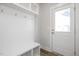 Entryway includes white millwork, convenient bench, and storage with hooks for organization at 912 Allen Park Dr, Raleigh, NC 27604