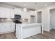 Modern kitchen with stainless appliances, sleek white cabinets, and stylish pendant lights at 912 Allen Park Dr, Raleigh, NC 27604