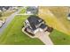 Aerial view of a two-story house with a three-car garage and landscaped yard at 25 Cotton Fields Ln # 29, Fuquay Varina, NC 27526