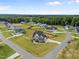 Aerial view of a new construction home in a community with lush greenery and a wooded area at 25 Cotton Fields Ln # 29, Fuquay Varina, NC 27526