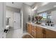Stylish bathroom featuring double vanity, white marble floors, elegant black fixtures, and soaking tub at 25 Cotton Fields Ln # 29, Fuquay Varina, NC 27526