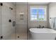 Modern bathroom with sleek glass shower, freestanding tub, matte black fixtures, and ample natural light at 25 Cotton Fields Ln # 29, Fuquay Varina, NC 27526