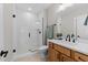 This bathroom features a glass shower and wood vanity with white countertops at 25 Cotton Fields Ln # 29, Fuquay Varina, NC 27526