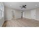 Large bedroom featuring wood-look flooring, neutral walls, white trim, and direct access to a bathroom at 25 Cotton Fields Ln # 29, Fuquay Varina, NC 27526
