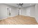 Spacious bedroom with wood floors, access to bathroom, and ceiling fan at 25 Cotton Fields Ln # 29, Fuquay Varina, NC 27526