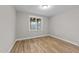 Well-lit bedroom with hardwood floors and a large window at 25 Cotton Fields Ln # 29, Fuquay Varina, NC 27526