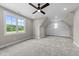 A bedroom features a large window that lets in plenty of light to the carpeted space at 25 Cotton Fields Ln # 29, Fuquay Varina, NC 27526