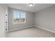 Well-lit bedroom with carpet, a window, and neutral walls at 25 Cotton Fields Ln # 29, Fuquay Varina, NC 27526