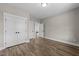 Bedroom with double doors and ample space for storage, featuring hardwood flooring at 25 Cotton Fields Ln # 29, Fuquay Varina, NC 27526