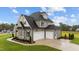 Two-story house with a three-car garage and stone accents at 25 Cotton Fields Ln # 29, Fuquay Varina, NC 27526
