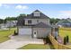 Charming home with a spacious three-car garage, lovely siding, and a screened-in porch at 25 Cotton Fields Ln # 29, Fuquay Varina, NC 27526