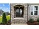 Elegant dark wood front door with arched entryway at 25 Cotton Fields Ln # 29, Fuquay Varina, NC 27526