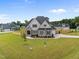 Stunning new construction home with beautiful stone accents, a landscaped yard and a three-car garage at 25 Cotton Fields Ln # 29, Fuquay Varina, NC 27526