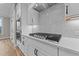 Kitchen features gas cooktop, white cabinets and quartz countertops at 25 Cotton Fields Ln # 29, Fuquay Varina, NC 27526