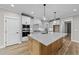 Modern kitchen with island, white cabinets and stainless steel appliances at 25 Cotton Fields Ln # 29, Fuquay Varina, NC 27526
