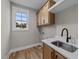 Laundry room with wood flooring, cabinets, and a utility sink at 25 Cotton Fields Ln # 29, Fuquay Varina, NC 27526