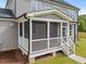 Charming screened porch with white railing and steps, offering a cozy outdoor retreat at 25 Cotton Fields Ln # 29, Fuquay Varina, NC 27526