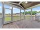 Inviting screened porch with wood flooring, ceiling fan, and backyard views, perfect for outdoor relaxation at 25 Cotton Fields Ln # 29, Fuquay Varina, NC 27526