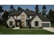 Two-story house with stone accents, dark gray shutters, and a three-car garage at 5428 Winding View Ln, Raleigh, NC 27615