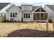 Rear exterior view highlighting siding, multiple windows and a covered patio with a ceiling fan at 205 Wash Hollow Dr, Wendell, NC 27591