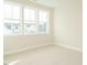 Bright bedroom with plush carpeting and three large windows offering plenty of natural light at 205 Wash Hollow Dr, Wendell, NC 27591
