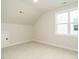 Cozy bedroom with neutral carpet, a dormer ceiling, and a bright window at 205 Wash Hollow Dr, Wendell, NC 27591