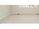 Neutral bedroom featuring plush carpeting, bright baseboards, and a large window at 205 Wash Hollow Dr, Wendell, NC 27591