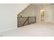 Bonus room with new carpet, staircase, railing and view of a bathroom and door at 205 Wash Hollow Dr, Wendell, NC 27591