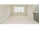 Bonus room with new carpet, natural light, staircase, and railing at 205 Wash Hollow Dr, Wendell, NC 27591