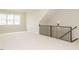 Spacious bonus room with new carpet, staircase, and railing at 205 Wash Hollow Dr, Wendell, NC 27591