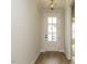 Bright foyer with hardwood floors, white walls, stylish pendant lighting, and front door with glass panels at 205 Wash Hollow Dr, Wendell, NC 27591