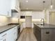 Modern kitchen featuring white cabinets, stainless steel appliances, granite countertops and large kitchen island at 205 Wash Hollow Dr, Wendell, NC 27591