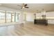 Open floorplan with hardwood floors that leads into the kitchen with a large center island and white cabinets at 205 Wash Hollow Dr, Wendell, NC 27591