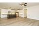 Open floorplan with hardwood floors that leads into the kitchen with a large center island and white cabinets at 205 Wash Hollow Dr, Wendell, NC 27591