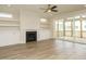 Spacious living room with hardwood floors, fireplace, built-in shelving, and sliding glass doors to the porch at 205 Wash Hollow Dr, Wendell, NC 27591