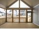 Inviting screened-in porch with wood flooring, vaulted ceiling, and views of the surrounding neighborhood at 205 Wash Hollow Dr, Wendell, NC 27591
