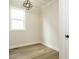Small room featuring hardwood floors, neutral walls, and a modern light fixture at 205 Wash Hollow Dr, Wendell, NC 27591
